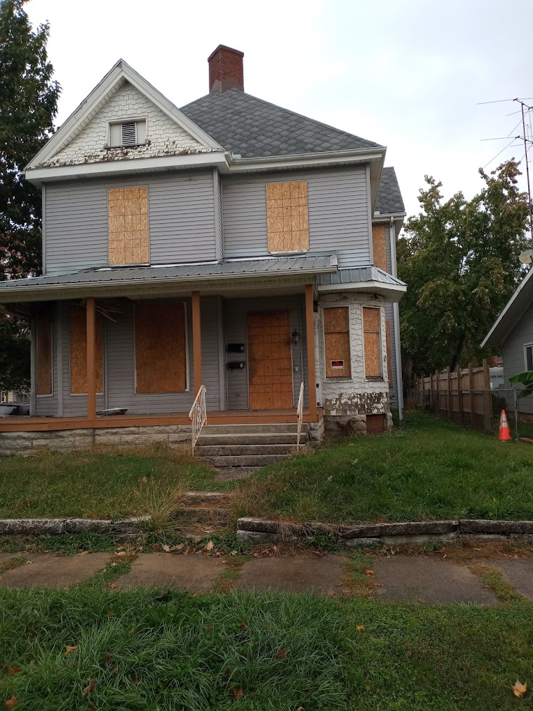 Boarded-up two-story house