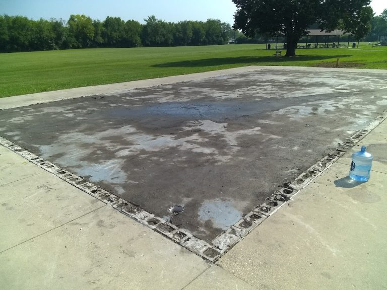 Cleared slab area beside a lawn
