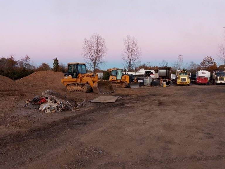 Heavy equipment in the yard at dusk