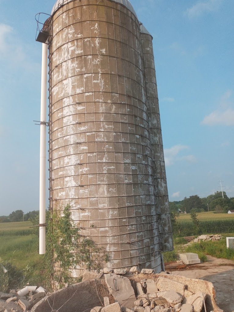 Concrete silo with broken concrete at its base