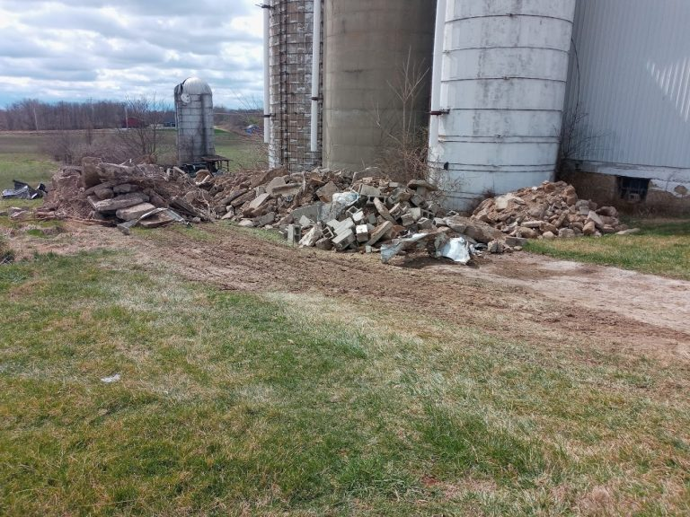 Concrete rubble beside silos