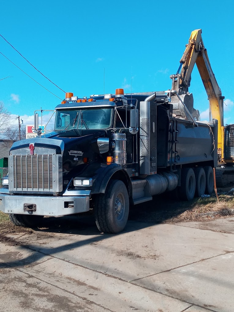Kenworth truck beside an excavator