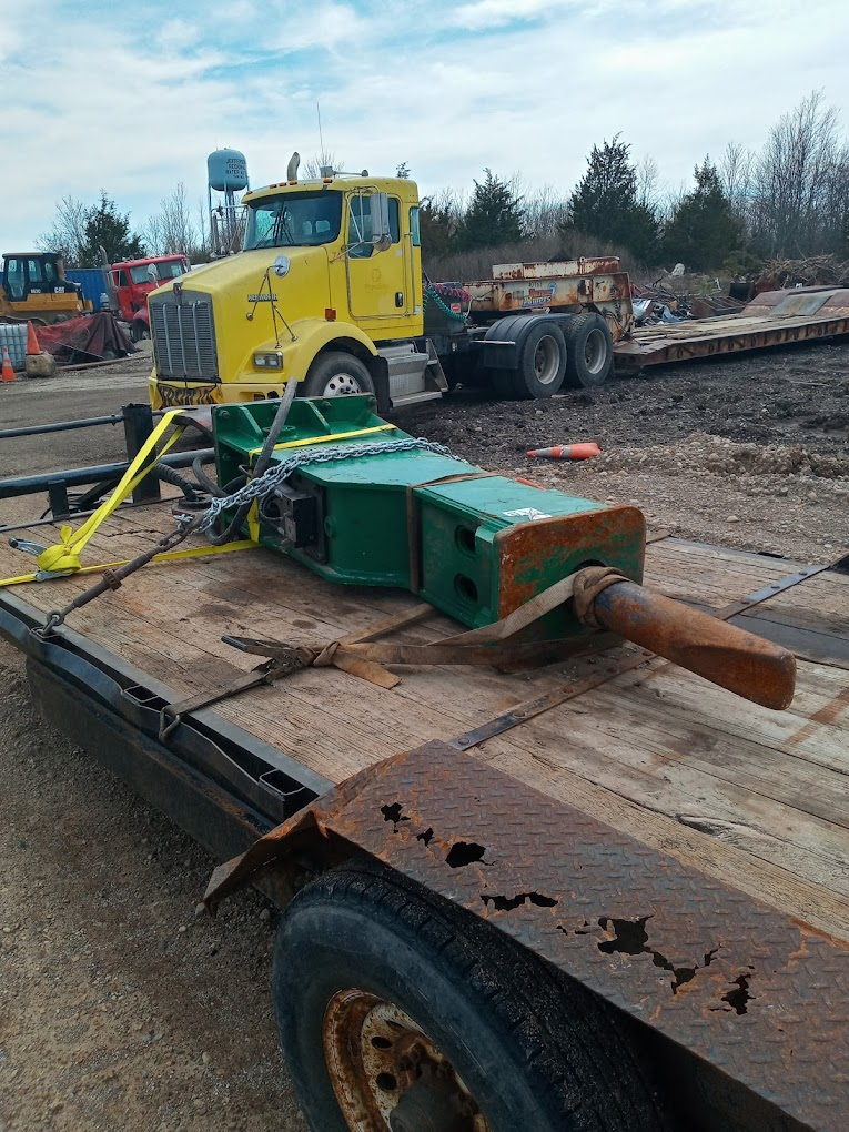 Hydraulic breaker strapped to a trailer