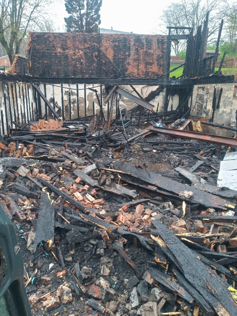 Debris from a fire-damaged brick building