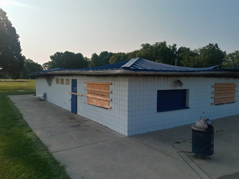Boarded-up building before work